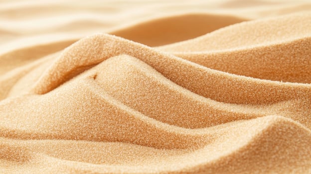 Golden sand dunes texture. Close up view of beach sand waves. Desert landscape with smooth shapes. Yellow and beige grain surface detail. photo