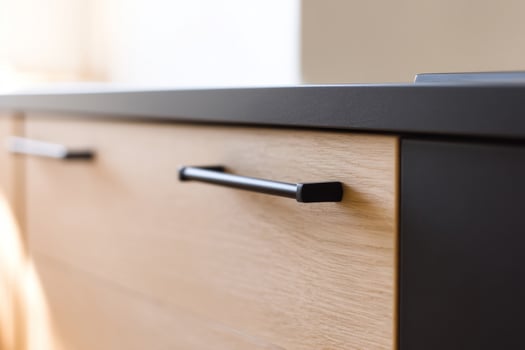 Black handle on wooden kitchen drawer photo