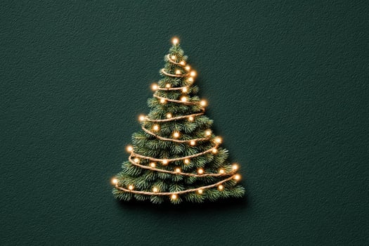 Decorated Christmas tree with lights on dark green background during holiday season photo