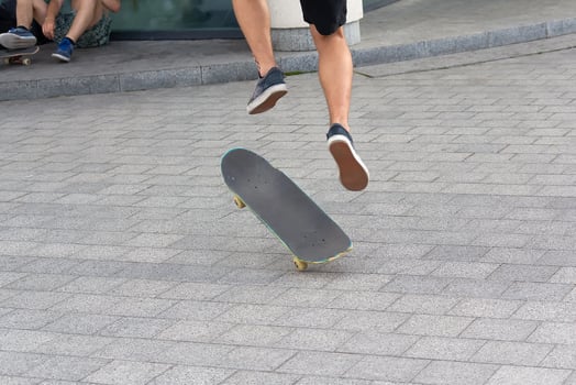 Teen ride a skateboard in the city photo