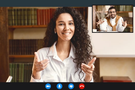 Remote Distant Communication Concept. Woman In Earphones Having Conference With Her Indian Colleague Or Boss, Talking And Gesturing At Camera During Online Call, Sitting At Desk In Home Office photo