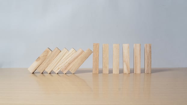 Stop wooden domino business crisis effect or risk protection concept photo