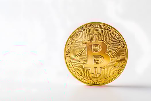 Closeup of a single golden Bitcoin coin isolated on white background for cryptocurrency concept photo