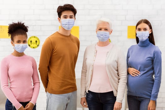 Coronavirus Vaccination. Group Of Covid-19 Vaccinated Diverse Patients In Face Masks Standing In Hospital, Looking At Camera. Covid Infection Immunization, Corona Virus Vaccine Concept photo