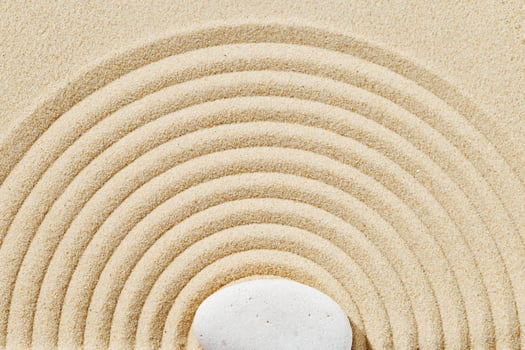 Zen garden meditation sandy background with stone cairn and lines on sand. Relaxation balance and harmony photo