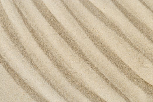 Lines drawing on sand, beautiful sandy texture. Spa background, concept for meditation and relaxation photo