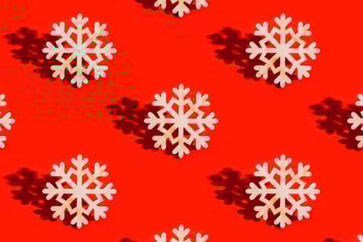 Christmas pattern with wooden snowflake on red Decoration for winter celebration New Year holiday concept photo