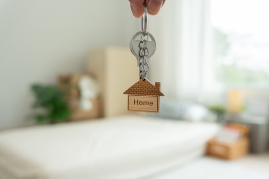 Moving house. relocation. Man hold key house keychain in new apartment. move in new home. Buy or rent real estate. flat tenancy, leasehold property, new landlord, investment, dwelling, loan, mortgage. photo