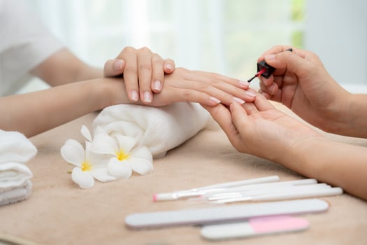 receive care service by professional Beautician Manicure at spa centre. Nail beauty salon use nail file for Glazing treatment. manicurist make nail customer to beautiful. body care spa treatment. photo