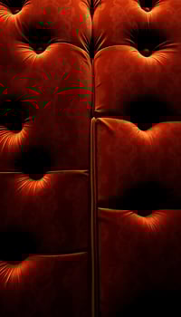 close up of a red couch with a black background photo