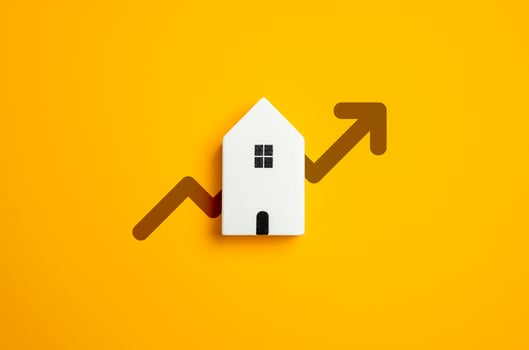 House and arrow pointing up. Rising prices. High demand for housing. Rising real estate prices. Improving housing conditions and living standards. Housing trends, market forecasts, or financial growth photo
