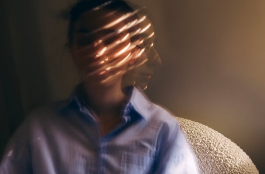 Close-up portrait of a young woman in casual clothes taken at long exposure photo