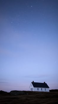Secluded Cottage under a Starlit Sky A Peaceful Night Landscape photo