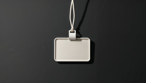 Blank rectangular tag placed on a dark background showcasing its simple design and potential for customization options photo