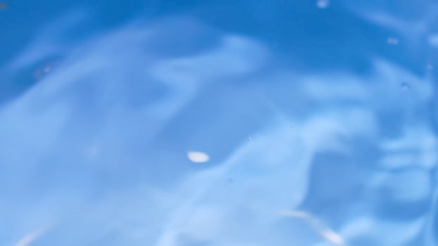 A close up of a blue liquid with bubbles photo