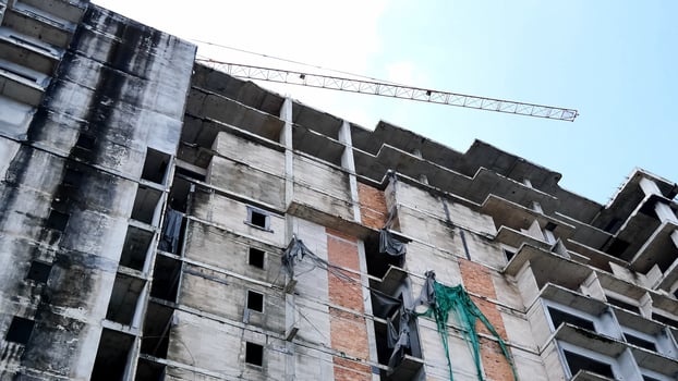 A building under construction with a crane on top photo
