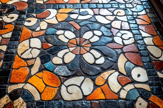 Colorful mosaic floor with floral pattern creating decorative surface photo