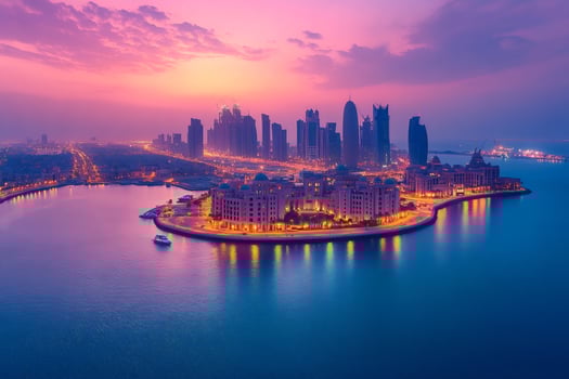 Doha skyline illuminating at dusk, qatar, persian gulf photo