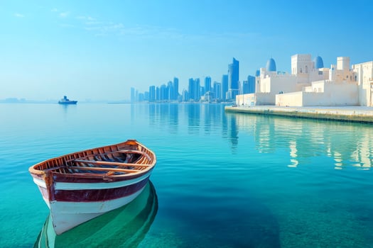 Wooden boat floating on calm water in doha bay with city skyline and museum of islamic art photo