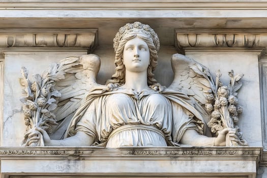 Majestic stone angel holding laurel wreaths photo