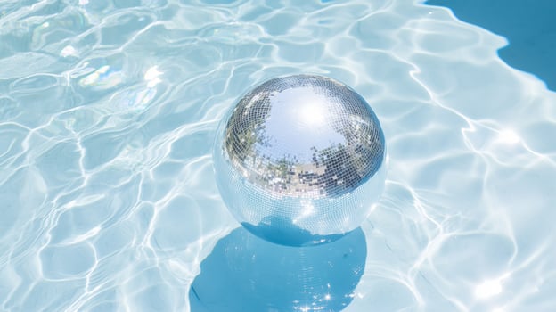 A shiny ball floating in a pool of water photo