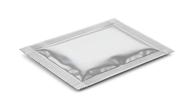 A silver packet of medicine on a white background photo
