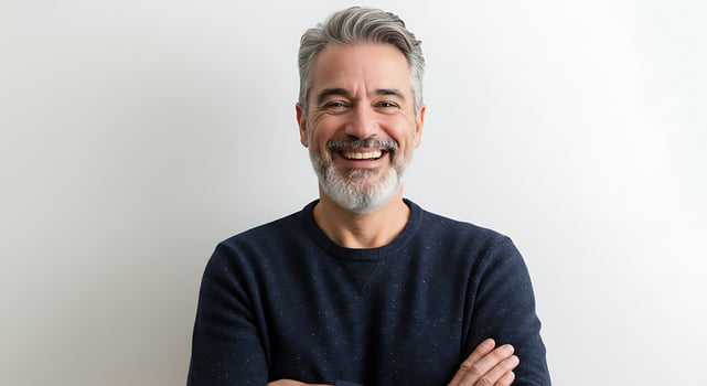 A man with a beard and grey hair smiling photo