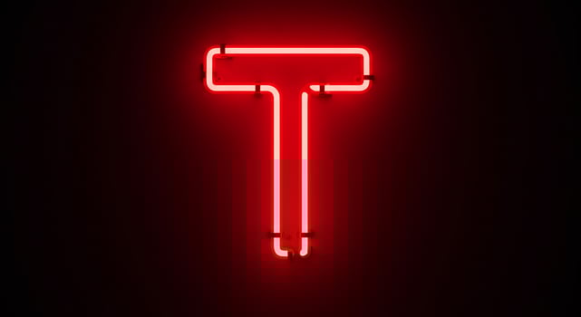 A red neon sign that says t photo