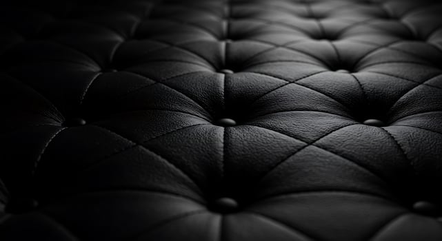 Black leather sofa with a dark background photo