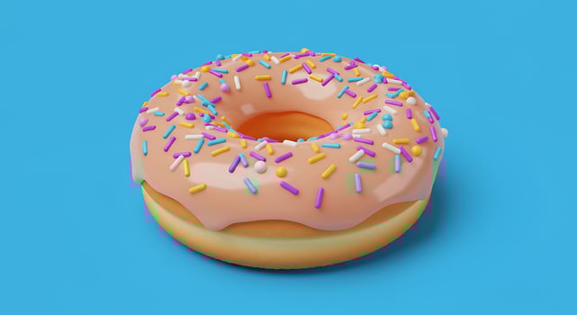 A donut with sprinkles on a blue background photo