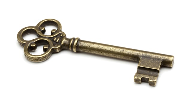 An old key on a white background photo