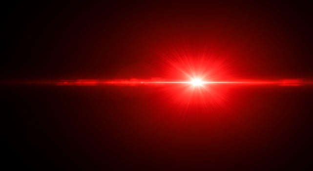 A red light shining on a black background photo