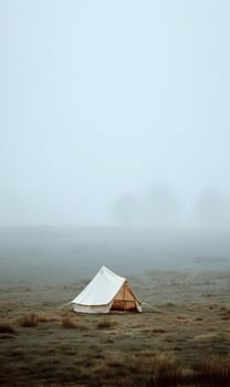 Solitary tent stands peacefully amidst misty field symbolizing quiet escape nature connection simplicity photo