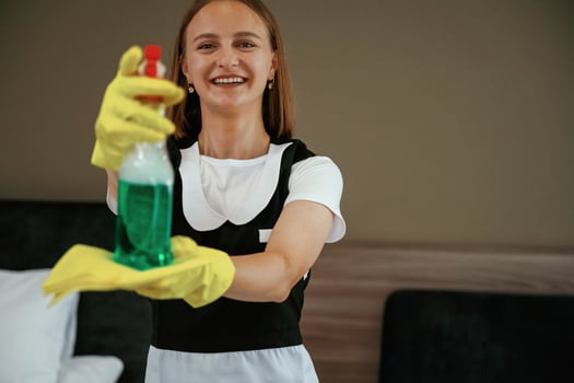 Young chambermaid is in hotel room. photo