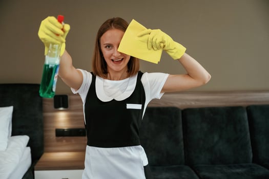 Surface cleaning, conception,. Young chambermaid is in hotel room photo
