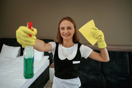 Surface cleaning, conception.. Young chambermaid is in hotel room photo