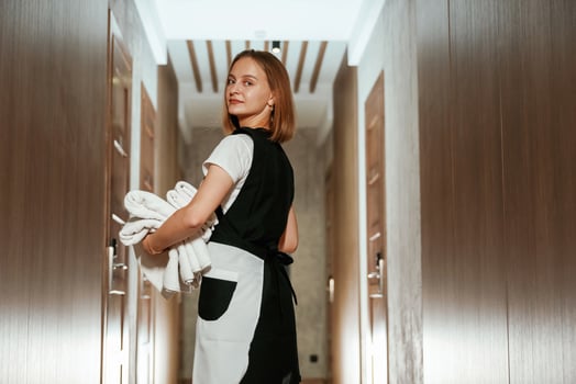 Ready for, work. Chambermaid is standing in the hotel corridor photo