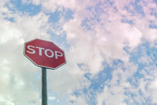 Road sign STOP with light cloudy sky in background. photo