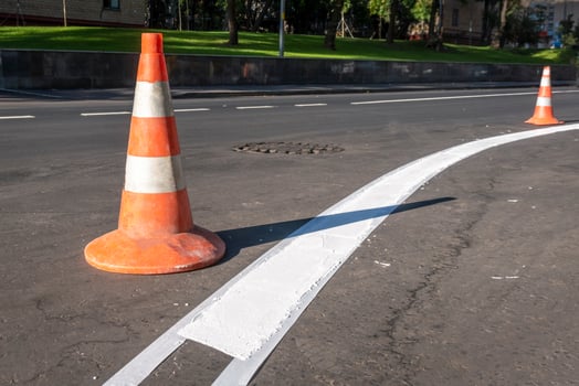 Manual road markings work. Road cone. Road work. photo