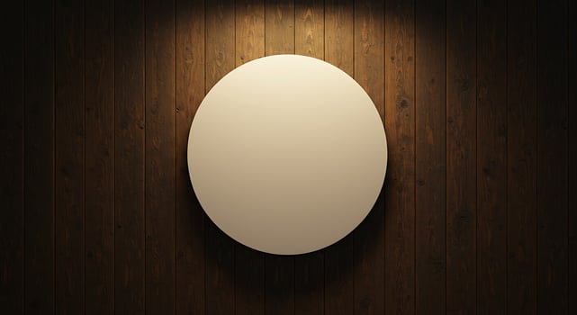 A white oval on a wooden wall photo