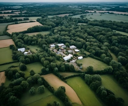 Small village surrounded by trees and fields in the english countryside photo