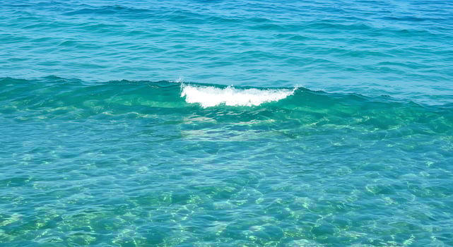 A wave is breaking on the ocean photo