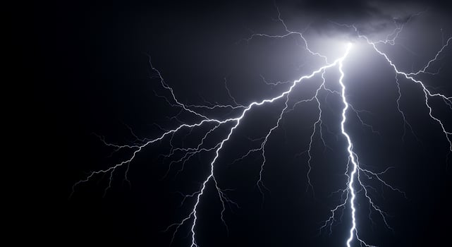 Lightning bolt striking the dark sky photo