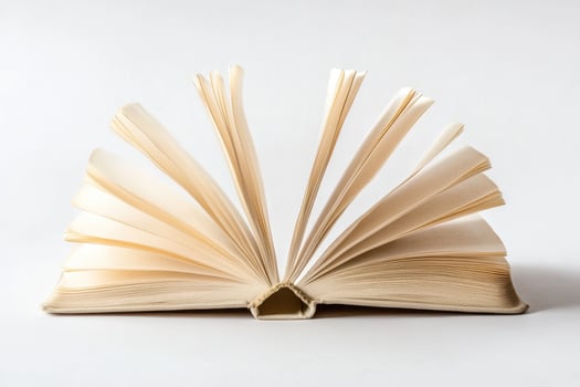 Open Book with Fanned Pages - Artistic Still Life on White photo