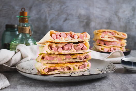 Grilled sandwiches in pita bread with sausage and cheese on a plate on the table photo