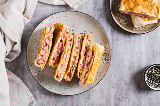 Grilled sandwiches in pita bread with sausage and cheese on a plate top view photo