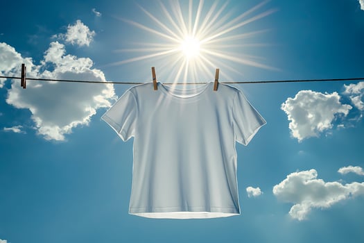 White t shirt hanging on clothesline drying under the sun photo