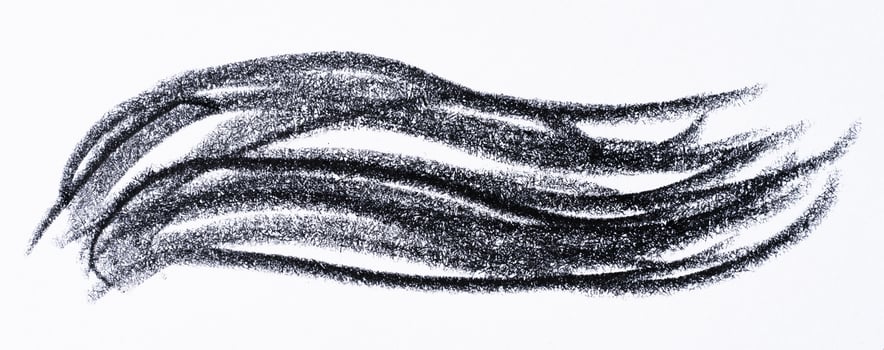 Close up of a wavy black pencil or charcoal stroke on an isolated background. photo