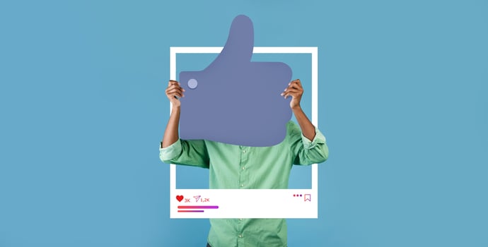 A person holds up a large thumbs up sign framed within a social media backdrop, promoting positivity. The blue background enhances the feeling of approval and connection for online influencers. photo