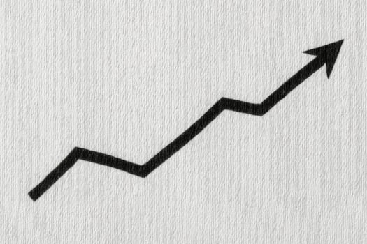 A black zigzag arrow pointing upward is depicted against a light gray textured background. The arrow symbolizes growth and progress, emphasizing a positive trend or increase. photo